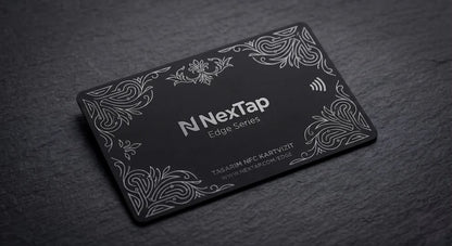 A black rectangular business card with a decorative border and text, placed on a dark surface.