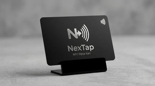 A black business card for NextTap, a NFC digital kiosk, is displayed on a stand.